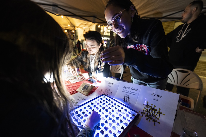 “Chemistry of Crystals” — As night falls during Science on the Square, an outreach team from the UW–Madison department of chemistry shows off luminescent crystals to explain how chemical structure is related to certain properties. (Photo by Jeff Miller / UW–Madison)