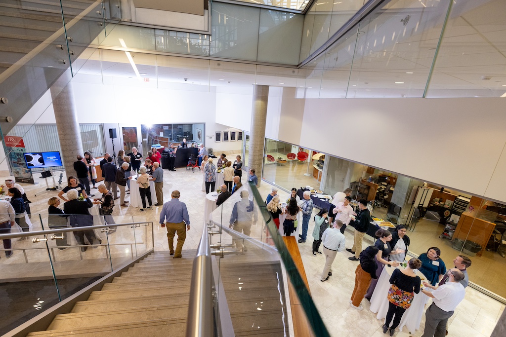 Guests make their way to the lower level of the Discovery Building, where the biomedical imaging labs are located.