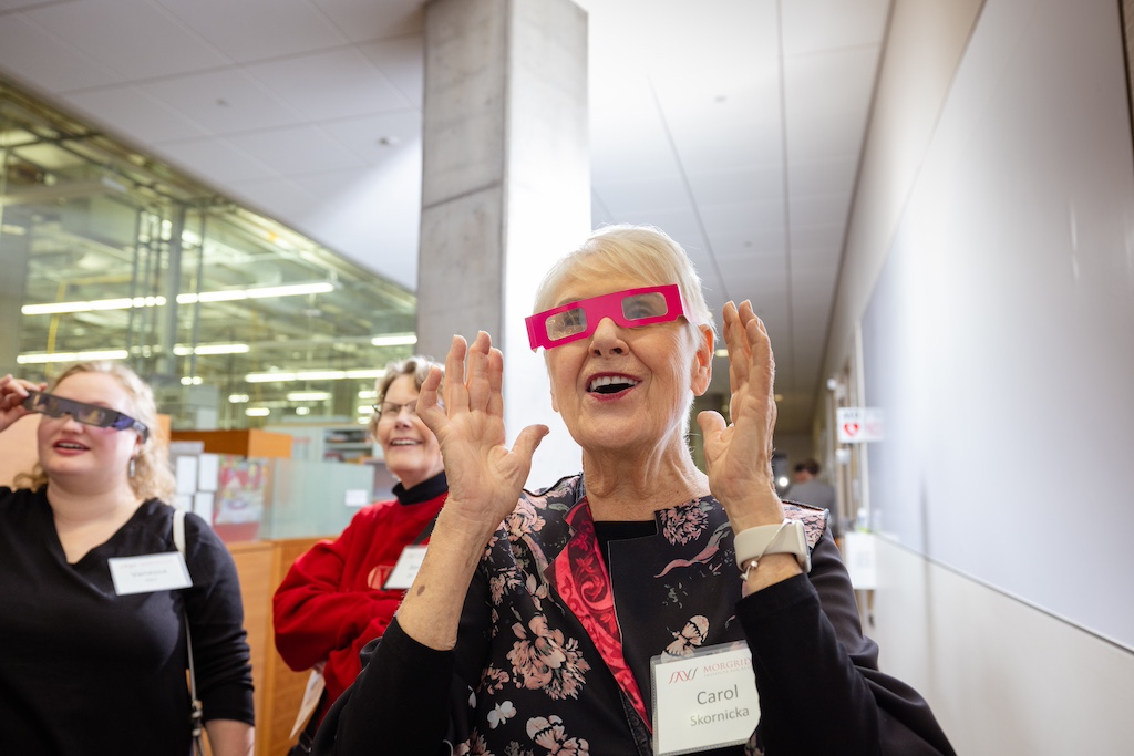 Attendees take a closer look at the properties of light to understand how the Skala Lab uses fluorescent imaging in their research.