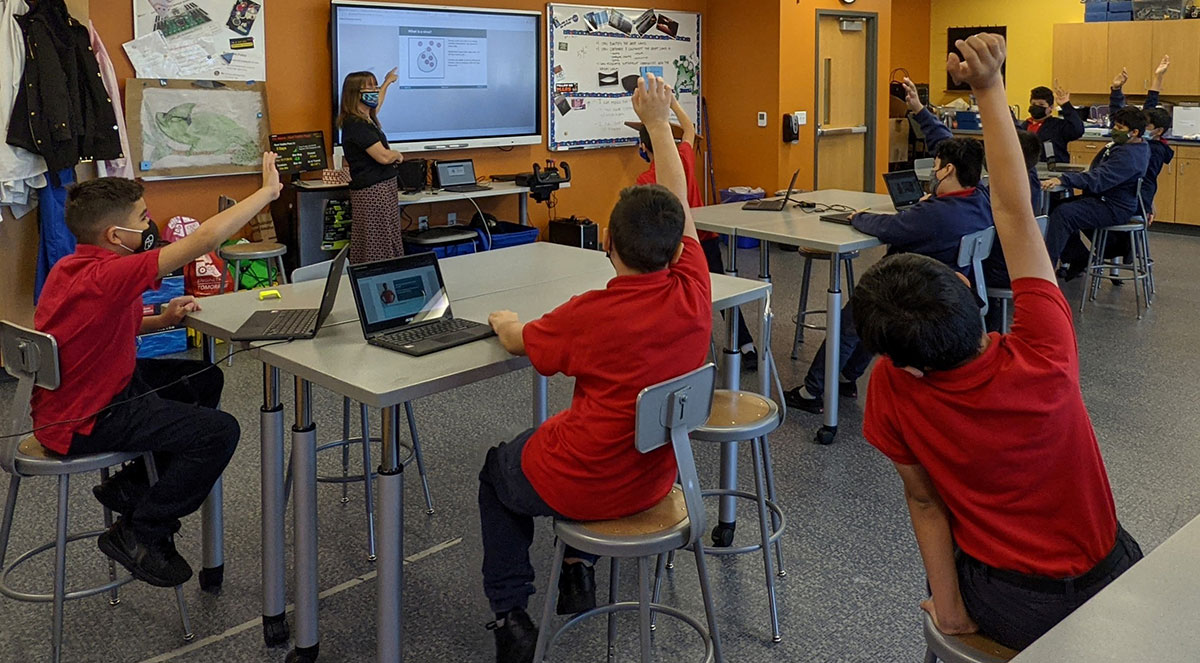 A classroom at Notre Dame School of Milwaukee learn how viruses infect cells through an exercise in Meet the Lab